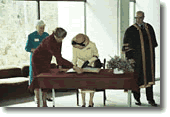 The Queen signing the guest book